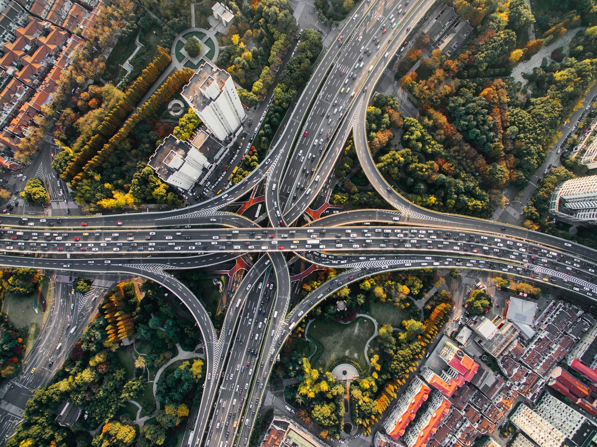 Aerial view of a highway interchange: many routes converging and separating.